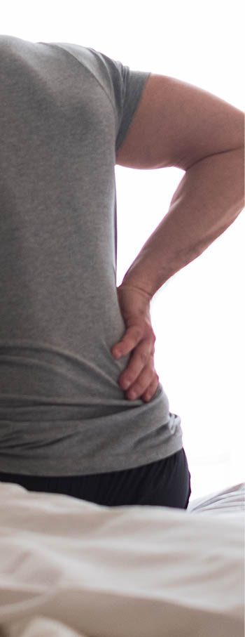 Man waking up in the morning and suffer for back pain